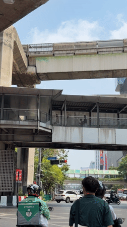 Motorcycle captures Bangkok's layered urban infrastructure at traffic light