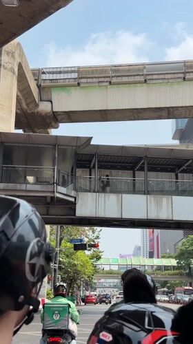 Motorcycle captures Bangkok's layered urban infrastructure at traffic light