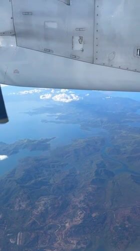 Passenger films aircraft wing during flight over Bitaugan, Philippines
