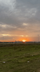 Orange sunset over a grassy field in Glokaron, Indonesia