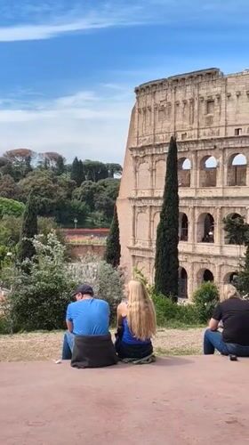 Tourists gather at Colosseum viewing areas in Rome