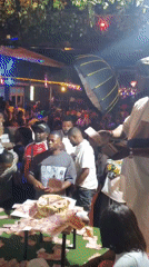 Nighttime crowd gathers around table in Nnewi, Nigeria