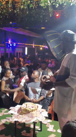 Nighttime crowd gathers around table in Nnewi, Nigeria