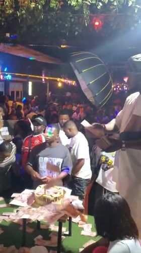 Nighttime crowd gathers around table in Nnewi, Nigeria