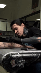 Tattoo artist works on client in Rostov-on-Don studio