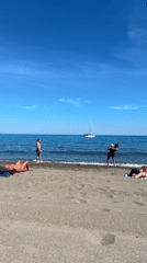 Beachgoers enjoy sunny afternoon at Málaga Mediterranean coast