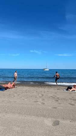 Beachgoers enjoy sunny afternoon at Málaga Mediterranean coast