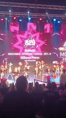 Young dancers perform colorful ballroom routines on stage