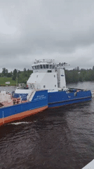Tugboats and barges conduct routine river transport near Анхимово