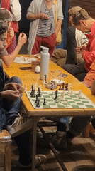Outdoor chess game at a café table in Vashisht