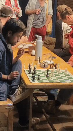 Outdoor chess game at a café table in Vashisht