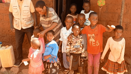 Community worker conducts family visits in rural DRC villages