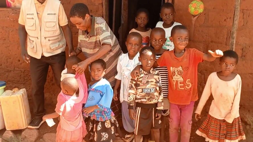 Community worker conducts family visits in rural DRC villages