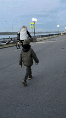 Child walks along river embankment in Yaroslavl