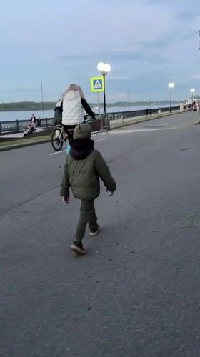 Child walks along river embankment in Yaroslavl
