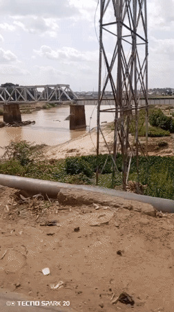 Metal bridge over muddy river observed in Barnawa, Nigeria