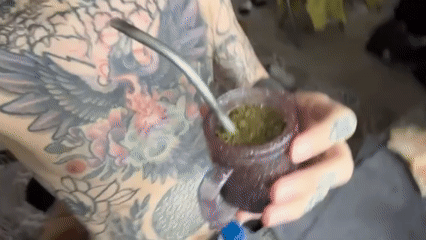 Tattooed person drinks mate on Buenos Aires streets