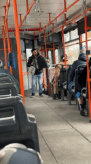 Street musician performs accordion on moving Sofia bus