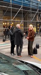 TV crew interviews blonde woman on Buenos Aires street