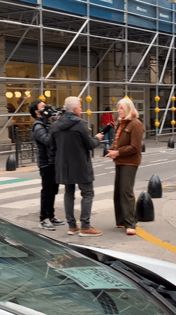 TV crew interviews blonde woman on Buenos Aires street