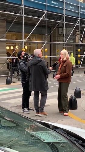 TV crew interviews blonde woman on Buenos Aires street