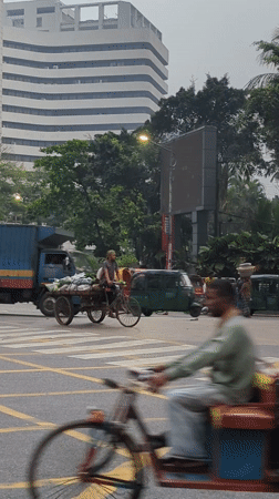 Dhaka street scenes show rickshaws, commerce in urban district