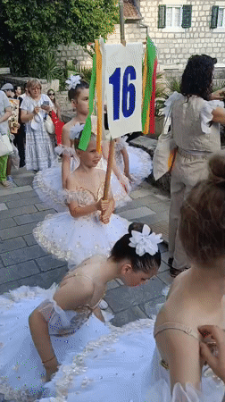 Children in tutus gather for street performance in Montenegro