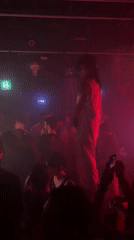 Live performance under red lights draws a crowd in Seoul