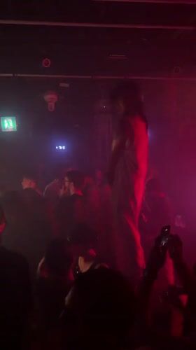 Live performance under red lights draws a crowd in Seoul