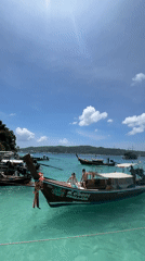 Island beach stop in Ko, Thailand, with boats and monkeys