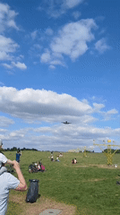 People gather near airport highway for plane watching activities
