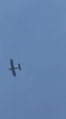 Aircraft and skydivers active over rural airfield Sunday morning