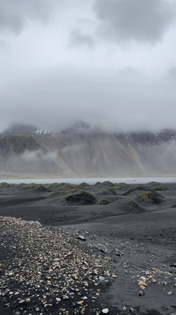 Tourist visits Iceland's black sand beach with Land Rover