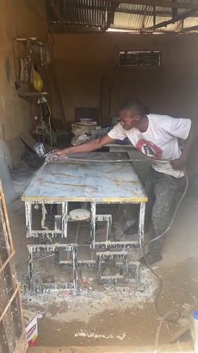 Nigerian artisans craft gold-veined countertop in outdoor workshop