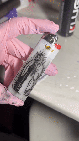 Person cleans Virgin of Guadalupe decorated lighter in Buenos Aires