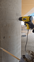Construction worker repairs concrete columns in Ramat Hasharon