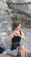 Street musician performs flute in Budva's Old Town
