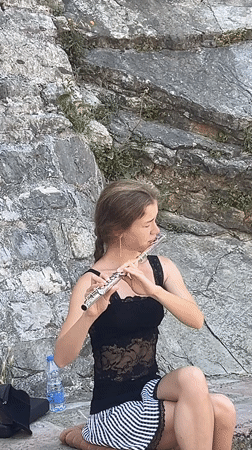 Street musician performs flute in Budva's Old Town