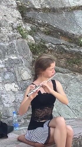 Street musician performs flute in Budva's Old Town