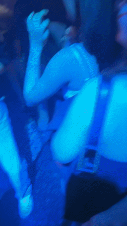 DJ performs at crowded Prague venue with colorful lighting