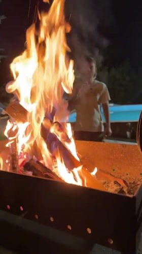 Evening backyard gathering with fire pit in Bulgarian village