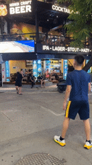 Hanoi street night: neon bars, market stalls, and street badminton