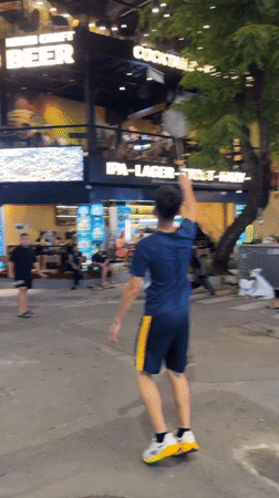 Hanoi street night: neon bars, market stalls, and street badminton