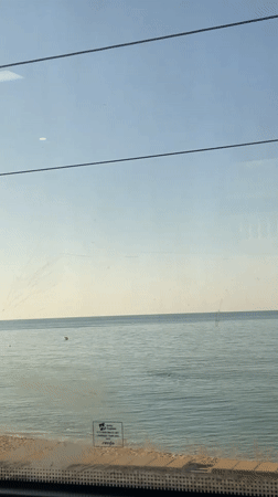Train passenger films calm Mediterranean waters near Barcelona