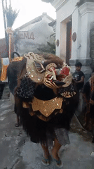 Ornate mythical creature costume at an outdoor cultural event