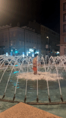 Man in red trunks enters illuminated fountain in Rijeka