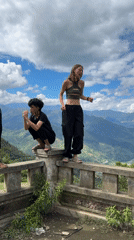 Young people dance on mountain overlook railings in Tu Le