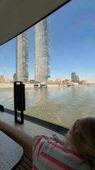 Child enjoys river tram journey viewing Moscow skyline