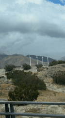 Wind turbines filmed against cloudy skies near Palm Springs