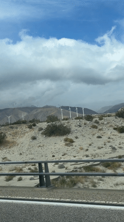 Wind turbines filmed against cloudy skies near Palm Springs